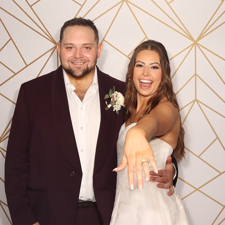 A bride and groom smiling in a photo booth of photo magic events of naples, florida