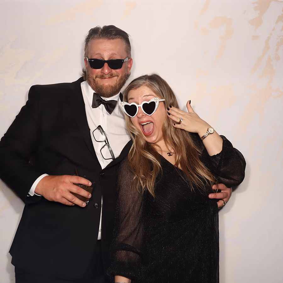 Engaged couple using a wedding photo booth rental from Photo Magic Events