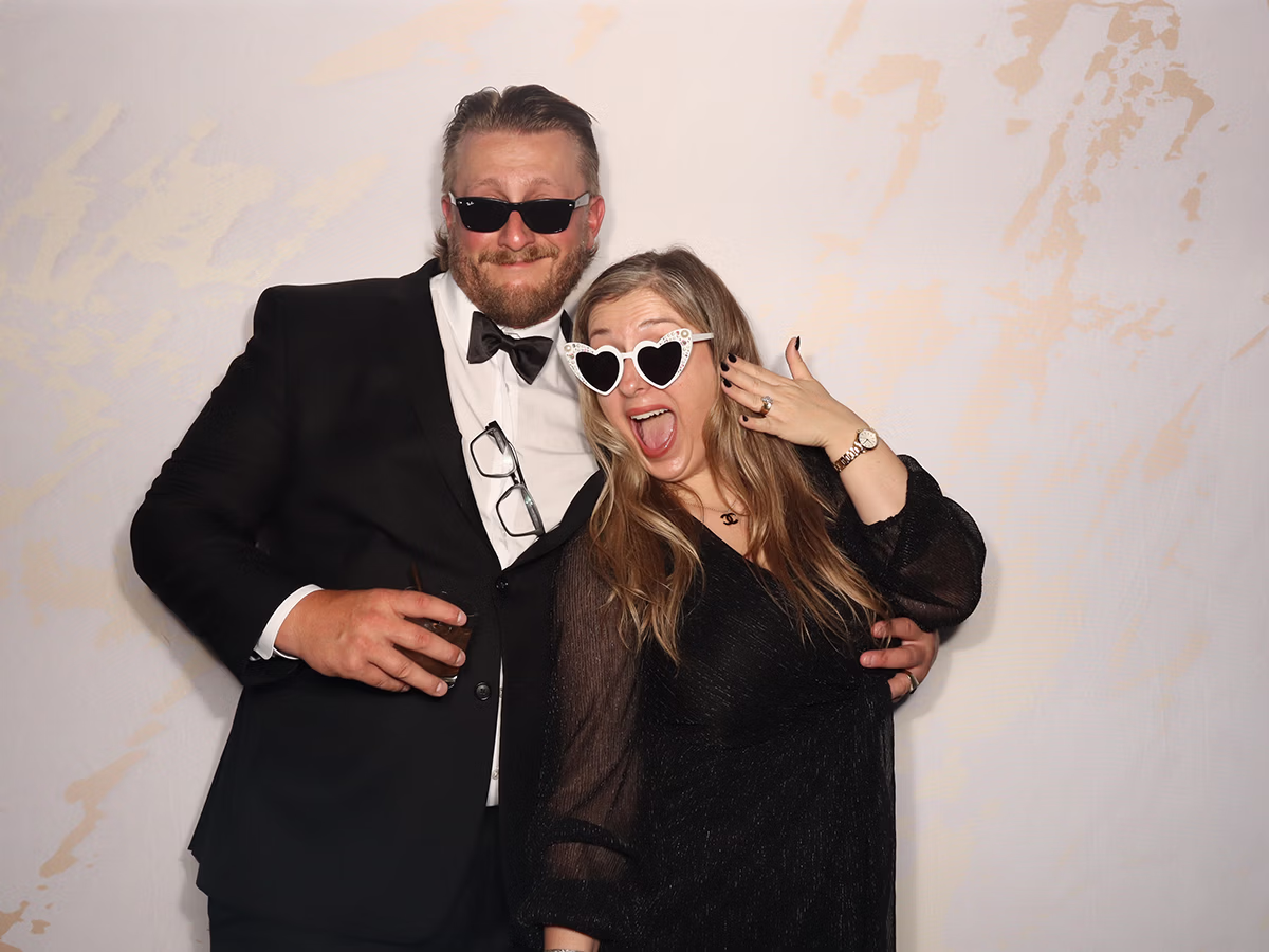 Engaged couple using a wedding photo booth rental from Photo Magic Events