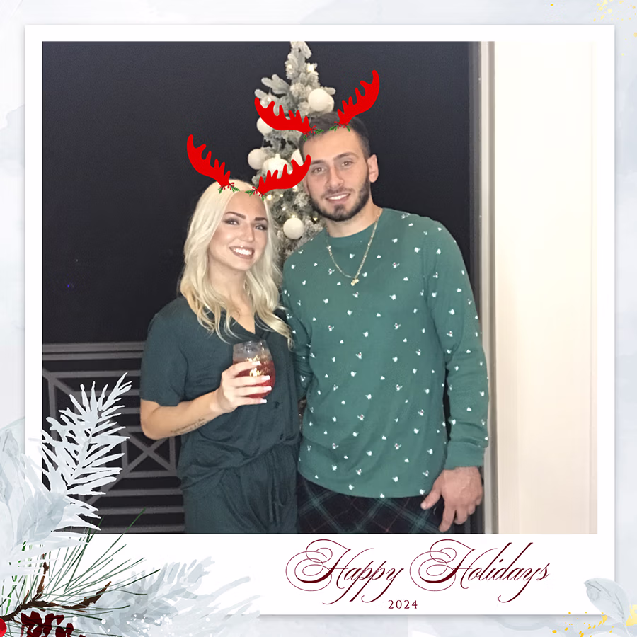 A couple with reindeer filter posing using the DIY Magic Photo Booth Rental at a Holiday Party in Southwest Florida