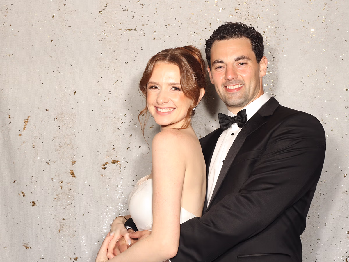 Newlywed couple smiling, enjoying their wedding photo booth rental by Photo Magic Events