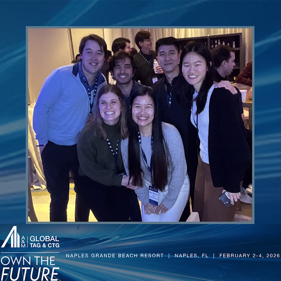 A group of young adults smiling in a roaming Photo Booth with a custom frame and company's logo