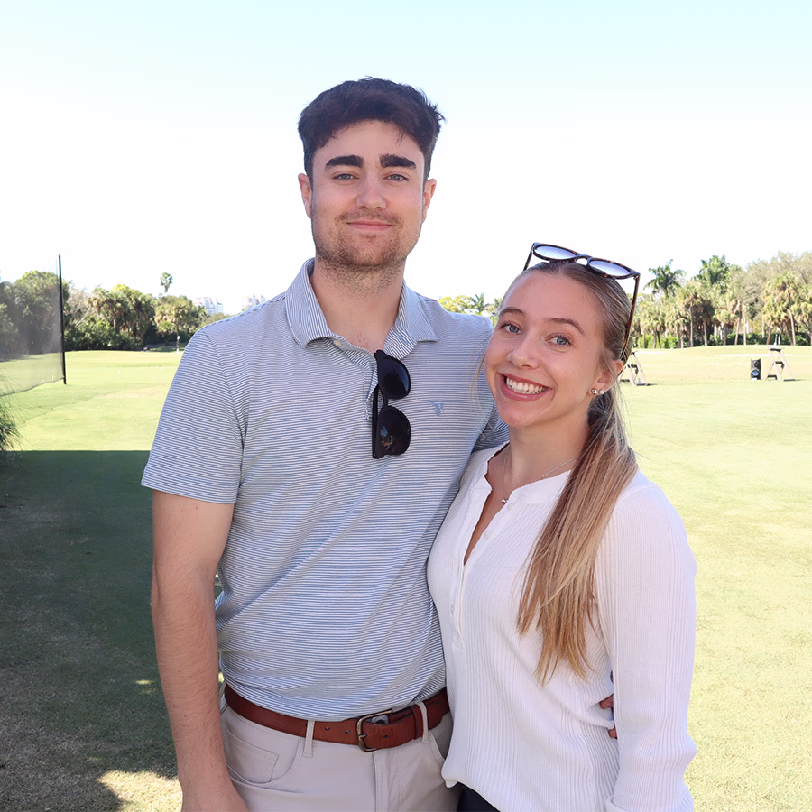 A couple smiling in a roaming Photo Booth at a golf course event