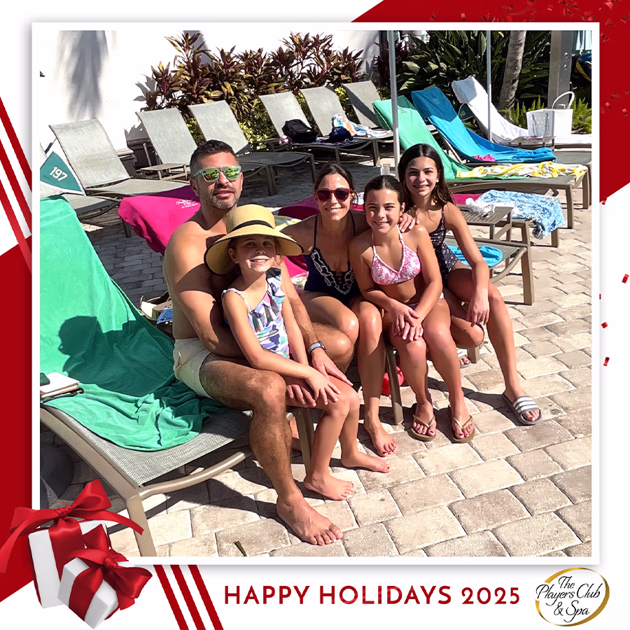 A family smiling in a Roaming Photo Booth by the pool in a custom frame