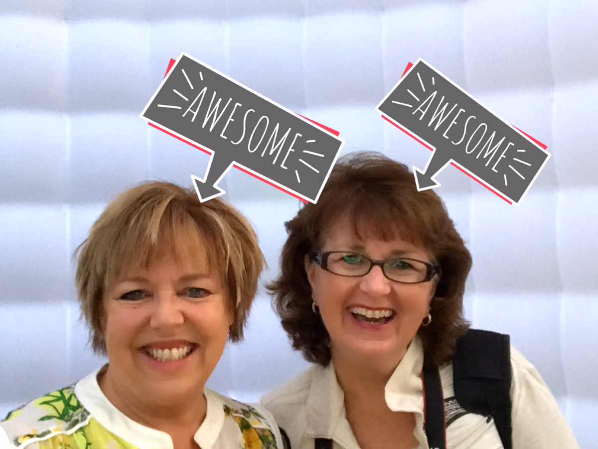 Photo Magic Events' founder Deb Newman and friend using the Roaming Magic Photo Booth Rental