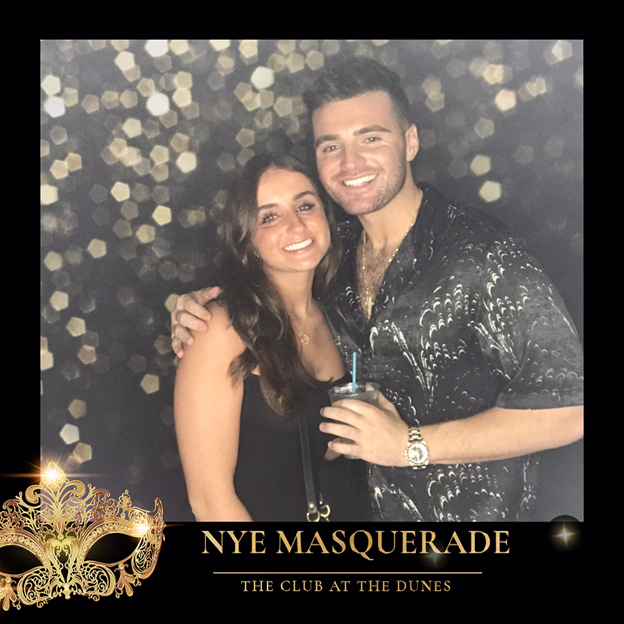 A couple at The Club at the Dunes NYE Masquerade party using the DIY Magic Photo Booth Rental