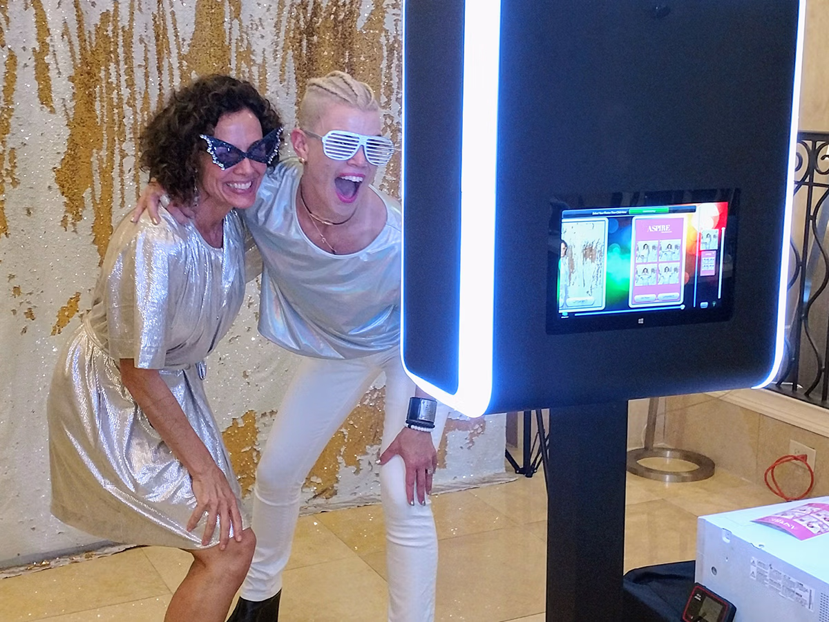 Two women using the Infinite Magic Photo Booth Rental from Photo Magic Events