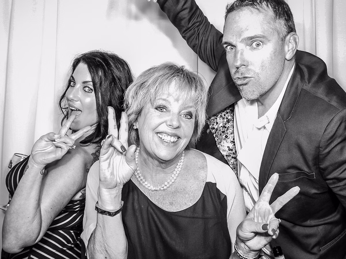 Wedding guests and Photo Magic Events founder Deb Newman enjoying a wedding photo booth rental